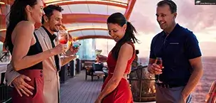 Two couples enjoying drinks and dancing on the deck of a Celebrity Cruises cruise ship at sunset