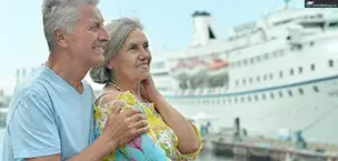 Cruise_Tips_And_Tricks Standing on a pier is a senior couple