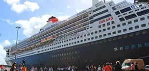 A large cruise ship named Queen Mary 2 sailing on the open sea.