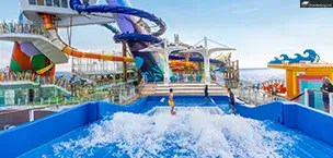 Man surfing on FlowRider wave simulator overlooking Category 6 Waterpark on Icon of the Seas ship.