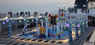 MSC cruise ship deck features a colorful water park with slides and lounging areas at sunset.