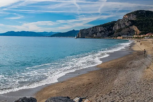 Celle Ligure Beach with sailboat, mountains