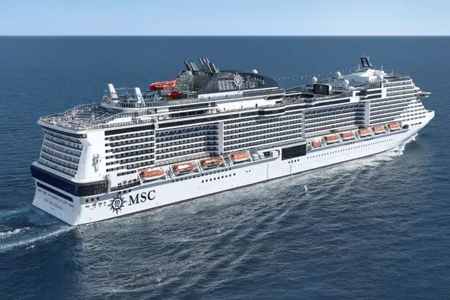 A large white cruise ship, the MSC Bellissima, sails through calm blue waters under a clear sky.