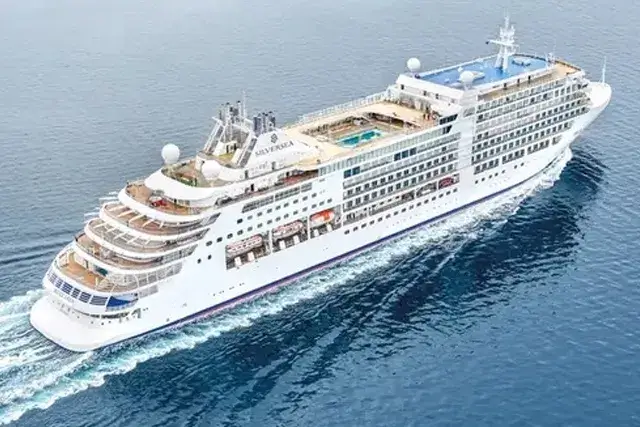 A large, white cruise ship named the Silver Moon sailing through the ocean.