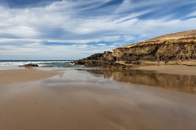 the sand of Jarugo Beach in Puerto del Rosario